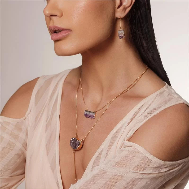 Model with earrings and necklaces with amethyst stone.